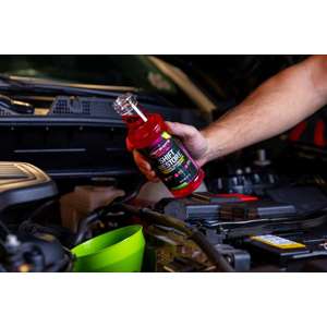 Adding Shift Restore transmission additive in an engine bay